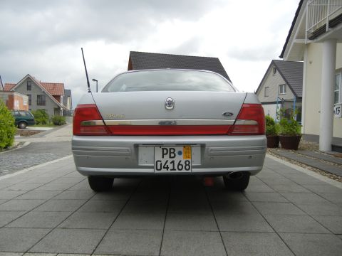 1999 Ford Fairlane - Rear view of a silver sedan, distinctive red taillights and a license plate.