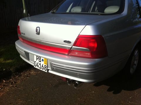 1999 Ford Fairlane - Rear view of a 1999 Ford Fairlane sedan showing its bumper, taillights, and license plate.