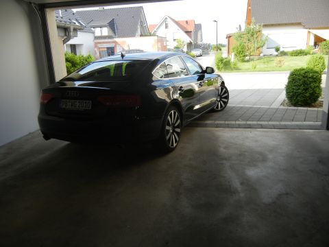 2010 Audi A4 - A black Audi is parked in a garage, with its rear facing the camera.