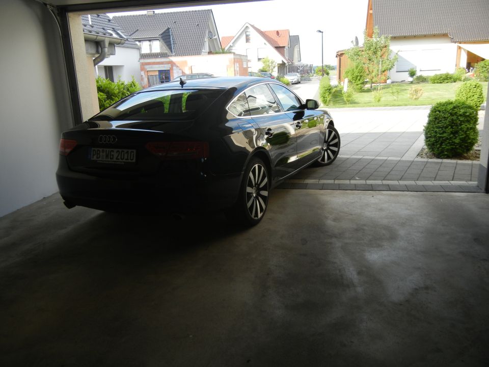 Black Audi with license plate PB WG 2010 parked in a garage