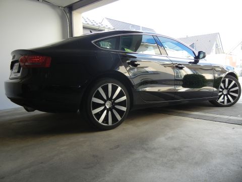 2010 Audi A4 - This black sedan features custom wheels and a profile, consistent with a 2010 Audi A4.