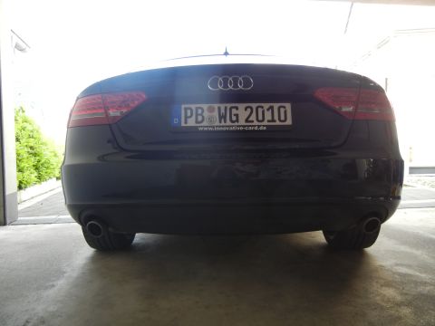 2010 Audi A4 - The rear of a dark colored Audi is shown, dual exhaust pipes and a license plate with the year 2010.