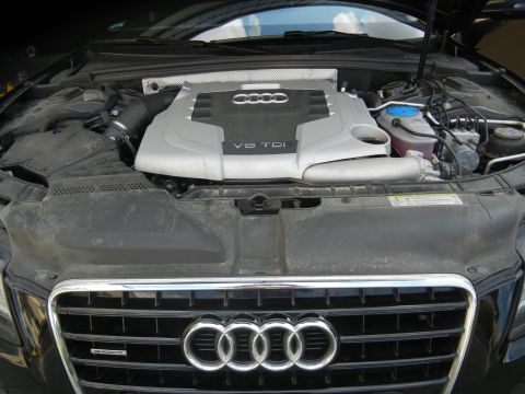 2010 Audi A4 - Engine bay view of an Audi with a V6 TDI engine and Quattro badging on the front grille.
