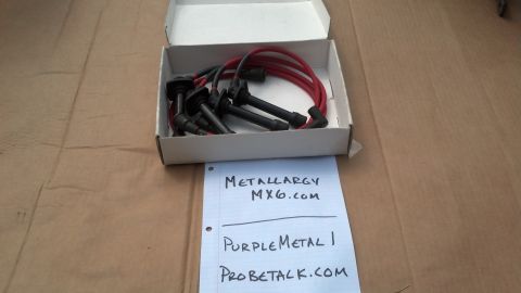 1994 Ford Probe - Spark plug wires are shown in their box with a handwritten note listing websites and a username.