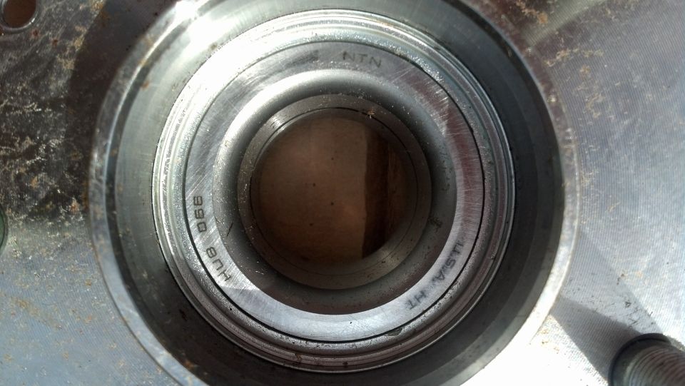 Close-up of a wheel bearing assembly with 'NTN' and 'HUB 066' markings