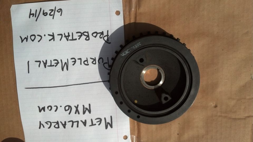 Crankshaft pulley with "VOKC10822C" stamped on it, next to handwritten notes