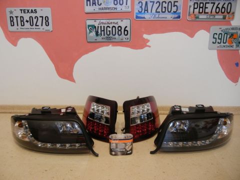 2003 Audi A6 - A pair of aftermarket LED headlights and taillights are displayed, along with a small container of automotive product.