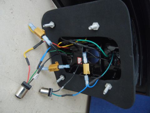 2003 Audi A6 - Close-up view of the internal wiring and components of a car light assembly, including resistors and bulb sockets.