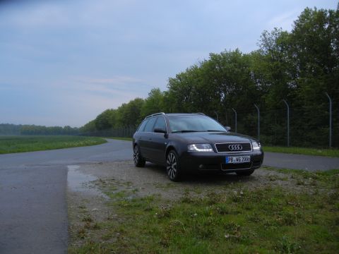 2003 Audi A6 - This Audi A6 wagon, identified by its license plate, is parked on the side of a road with trees and a field in the background.