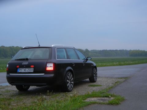 2003 Audi A6 - A black Audi A6 wagon is parked on the side of a road with a field in the background.