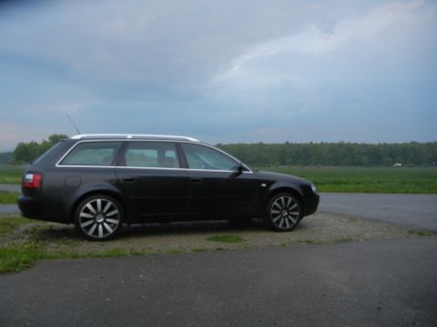 2003 Audi A6 - This black Audi A6 Avant is shown from the side, aftermarket wheels and a scenic backdrop.