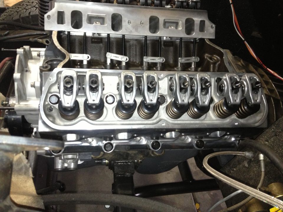 Close-up of V8 engine with polished aluminum valve covers and intake manifold
