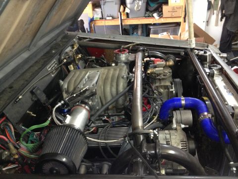 1961 International Scout 800 - The engine bay of a vehicle is shown with various engine components and wiring visible.