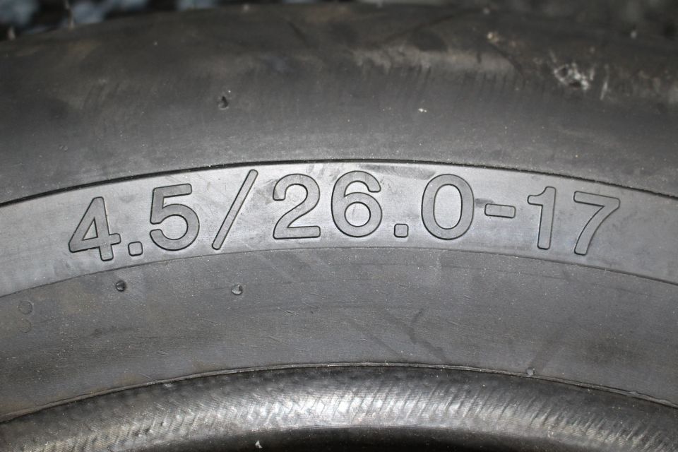 Close-up of tire sidewall showing molded size marking 4.5/26.0-17