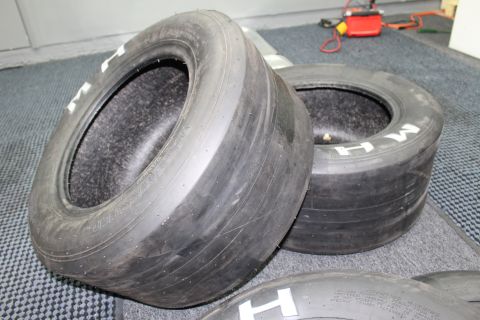 2003 Ford Crown Victoria - Two wide M&H drag slicks with white M H lettering on a blue-gray carpet.