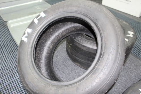 2003 Ford Crown Victoria - M&H Racemaster drag slick showing its open center and white sidewall lettering.