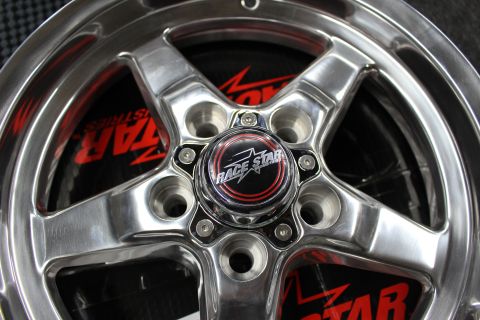 2003 Ford Crown Victoria - Extreme close-up of a polished wheel hub with a Race Star center cap and surrounding lug holes.
