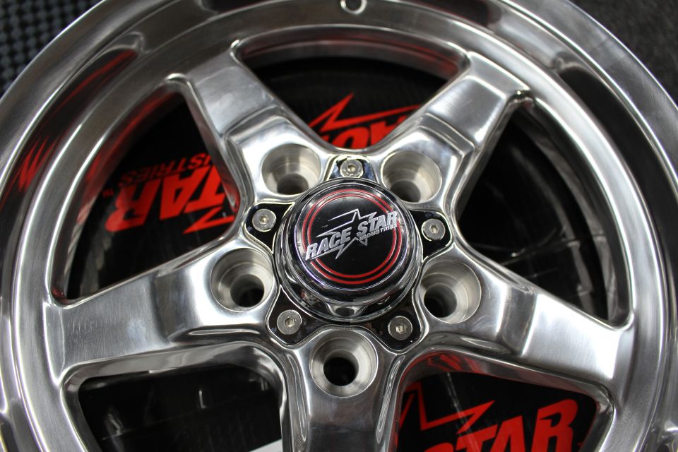 Extreme close-up of Race Star wheel center cap and lug bolts
