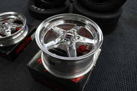 2003 Ford Crown Victoria - polished deep-lip Race Star five-spoke wheel sits face-up on its box on a garage mat.