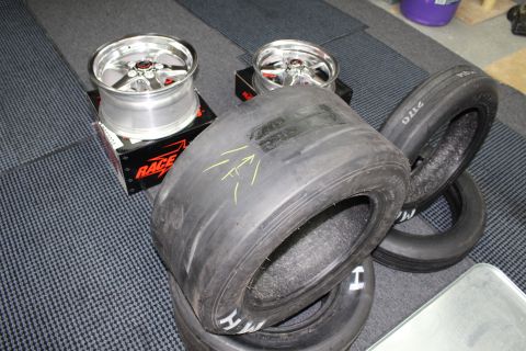 2003 Ford Crown Victoria - Polished Race Star five-spoke wheels sit on boxes behind a pair of M/H drag slick tires in a garage.