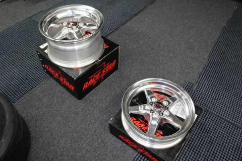 2003 Ford Crown Victoria - Two polished Race Star five-spoke drag wheels sit on branded boxes on a checkered garage mat.