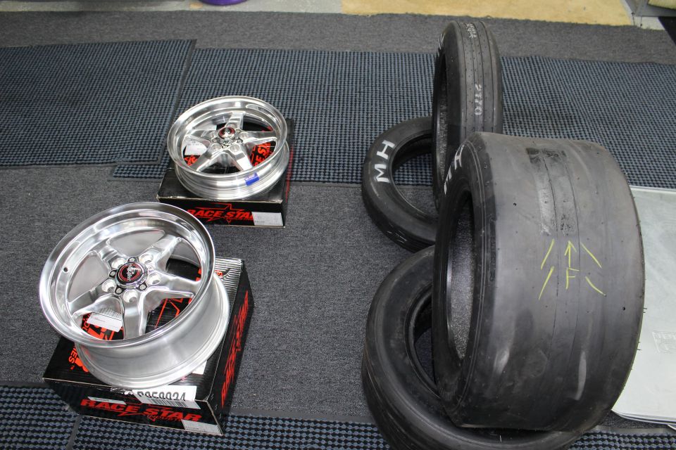 Polished Race Star wheels on boxes beside wide M/H drag slicks