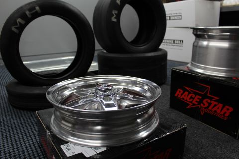 2003 Ford Crown Victoria - polished smooth-face aluminum drag wheel sits in front of M/H drag tires and a Race Star Industries box.