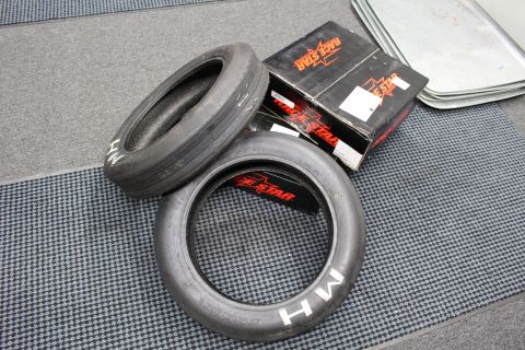 2003 Ford Crown Victoria - Two narrow M/H drag front-runner tires rest on the floor next to a black-and-orange Race Star box.