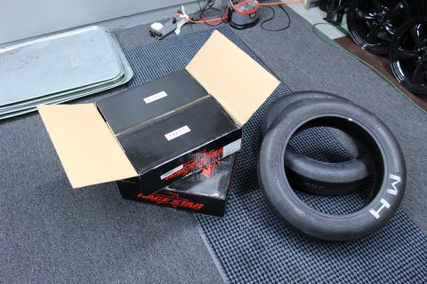 2003 Ford Crown Victoria - open Race Star carton holds inner wheel boxes next to an M/H drag tire on a workshop floor.