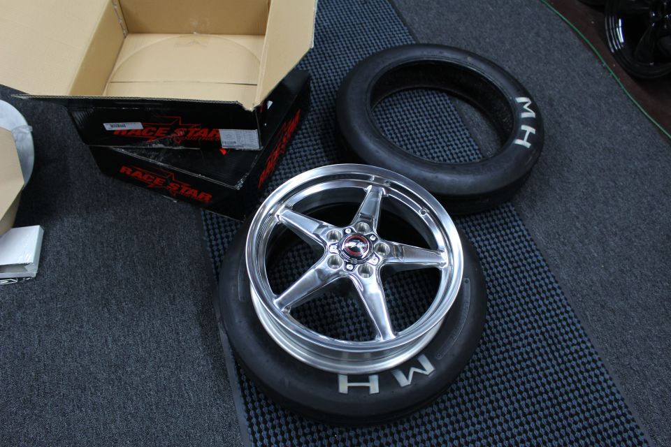 Polished 5-spoke wheel sitting in an M/H tire with Race Star box