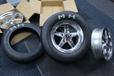 2003 Ford Crown Victoria - polished five-spoke wheel on an MH drag slick sits between a bare polished drag wheel and a skinny MH tire.