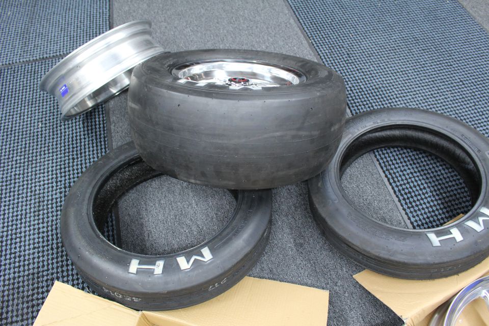 Wide slick on polished wheel stacked over two skinny MH tires