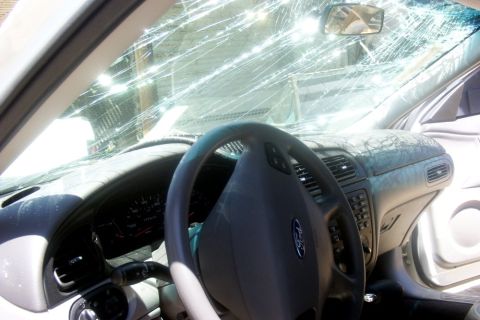 2000 Ford Taurus - Interior of a 2000 Ford Taurus showing a severely cracked windshield and worn dashboard.