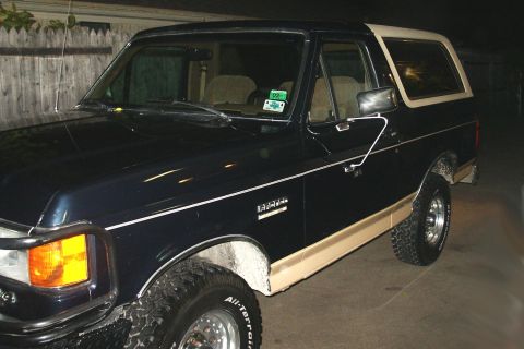 1991 Ford Bronco - This 1991 Ford Bronco features a two-tone paint scheme with dark blue and tan accents.
