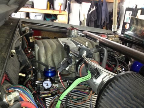 1961 International Scout 800 - Close-up of a modified engine bay, showing custom fuel and intake systems.
