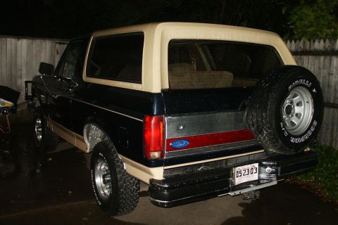 1991 Ford Bronco - Rear view of a 1991 Ford Bronco, a two-tone paint scheme and a mounted spare tire.