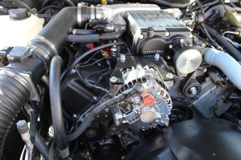 2003 Ford Crown Victoria - close-up of an engine bay shows a Kenne Bell supercharger above a chrome alternator and belt drive.