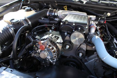 2003 Ford Crown Victoria - engine fitted with a Kenne Bell supercharger shows a blue coolant hose, chrome alternator and belt drive.