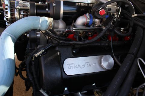 2003 Ford Crown Victoria - Engine bay showing a Kenne Bell supercharger above a black Trick Flow-badged valve cover and a routed light-blue intake pipe.