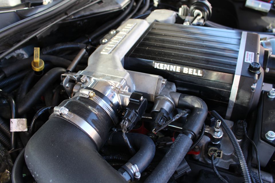 Close-up of Kenne Bell supercharger top with throttle body and intake hose
