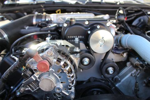 2003 Ford Crown Victoria - Detail of a black Kenne Bell supercharger with a smooth idler pulley and a chrome alternator with red cap mounted below it.
