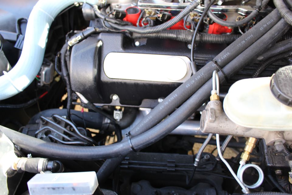Black engine valve cover with brake master cylinder and reservoir