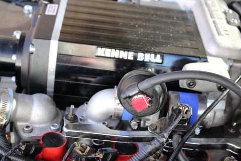 2003 Ford Crown Victoria - Close-up of a black Kenne Bell supercharger with its badge above a polished intake manifold and red oil-fill cap.