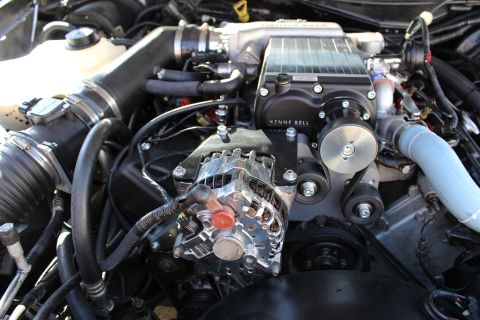 2003 Ford Crown Victoria - Kenne Bell supercharger with finned intercooler sits over the engine intake alongside a chrome alternator and serpentine belt.