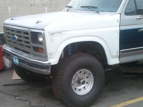 1986 Ford Bronco - This Ford Bronco, likely from the early 1980s, is shown from the front quarter with modifications.