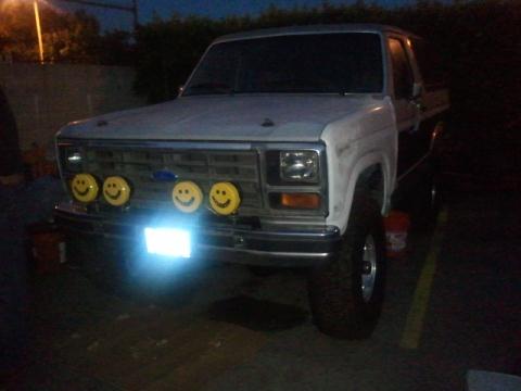 1986 Ford Bronco - This 1986 Ford Bronco features a unique set of four yellow smiley face lights mounted on its grille.
