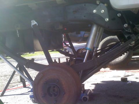 1986 Ford Bronco - Rear suspension components including leaf springs and a shock absorber are visible in this close-up shot.