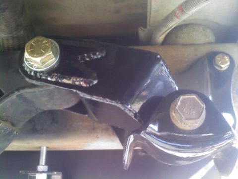1986 Ford Bronco - Close-up of a vehicle's suspension bracket, showing bolted components and metalwork.
