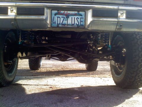 1986 Ford Bronco - The rear suspension and axle of a 1986 Ford Bronco are visible, a California license plate.
