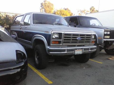 1986 Ford Bronco - This 1986 Ford Bronco features a distinctive two-tone paint scheme and a prominent grille.